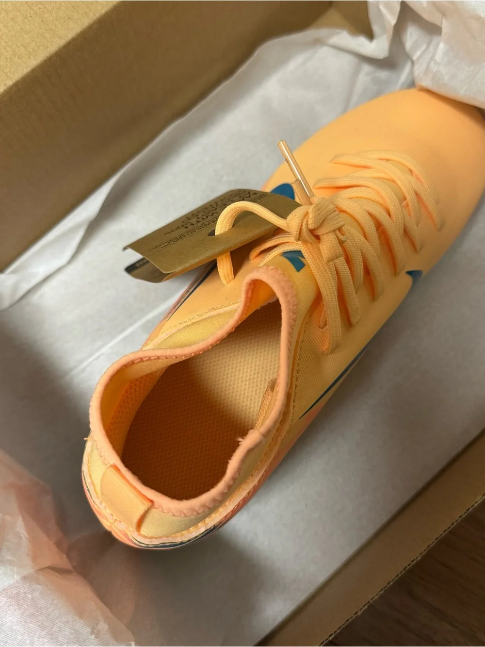 Nike Kids Orange Soccer Cleats with Blue Swoosh